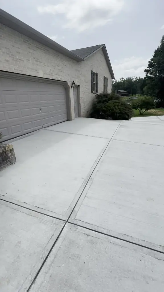 Concrete driveway running up to a two-car garage in Knoxville, Tennessee